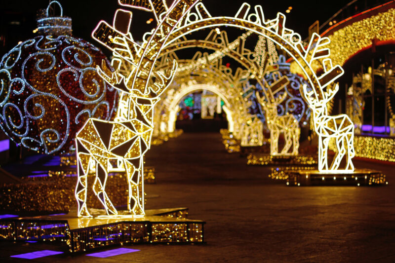 Abstract background of light tunnel with deers and Christmas balls with defocused lights